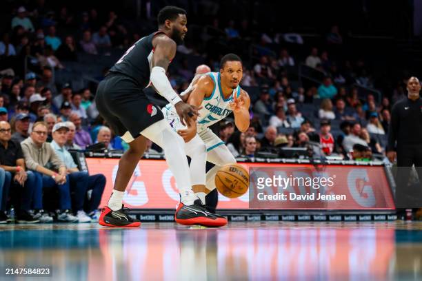 Grant Williams of the Charlotte Hornets passes the ball during the first half of a basketball game against the Portland Trail Blazers at Spectrum...