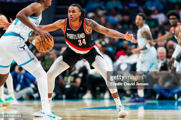 Jabari Walker of the Portland Trail Blazers defends Brandon Miller of the Charlotte Hornets during the second half of a basketball game at Spectrum...