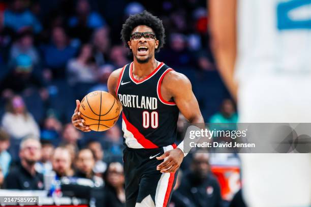 Scoot Henderson of the Portland Trail Blazers brings the ball down the court during the second half of a basketball game against the Charlotte...