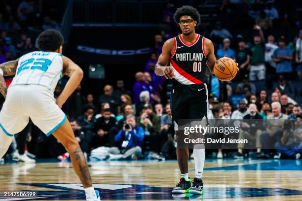 Scoot Henderson of the Portland Trail Blazers brings the ball down the court during the second half of a basketball game against the Charlotte...