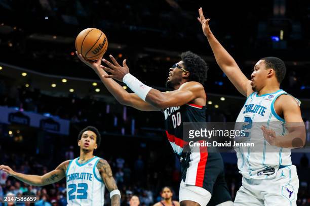 Scoot Henderson of the Portland Trail Blazers lays the ball up during the second half of a basketball game against the Charlotte Hornets at Spectrum...