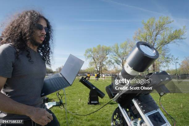 Jim James, from Aurora, Illinois, prepares his equipment to photograph the total eclipse from a field on the campus of Southern Illinois University...