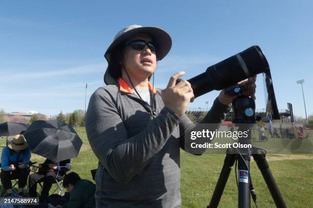 Joseph Cervantes from Santa Clara, California prepares his equipment to photograph the total eclipse from a field on the campus of Southern Illinois...