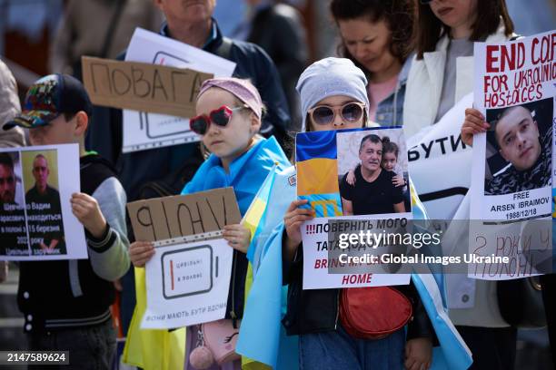 Child holds a banner that reads 'Bring my daddy home' during the rally on Maidan Nezalezhnosti Square on April 6, 2024 in Kyiv, Ukraine. Rally in...