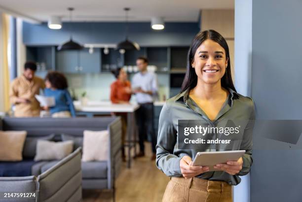 happy businesswoman working on a digital tablet at the office - looking at camera stock pictures, royalty-free photos & images