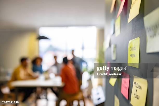brainstorming über eine social-media-strategie im büro - klebezettel stock-fotos und bilder