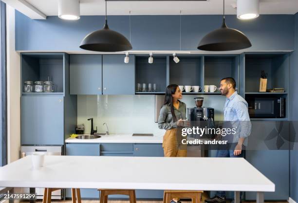 coworkers talking in the cafeteria while taking a break at the office - canteen stock pictures, royalty-free photos & images