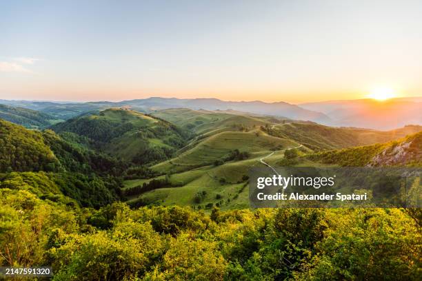 picturesque landscape with hills and carpathian mountains in transylvania, romania - alps romania stock pictures, royalty-free photos & images