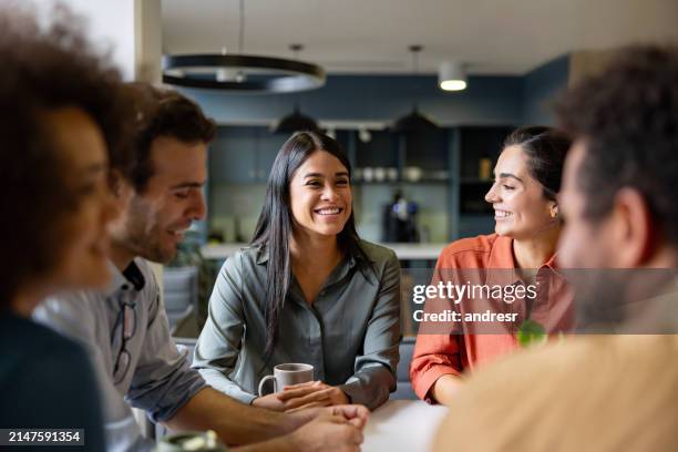 happy businesswoman smiling in a meeting at the office - onderhandelen stockfoto's en -beelden