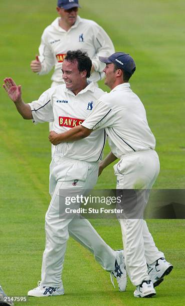 Warwickshire paceman Neil Carter celebrates after taking the wicket of Graham Thorpe during the Frizzell County Championship Game Between...