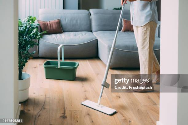 efficient home cleaning with modern mop and bucket - wooden floor stock pictures, royalty-free photos & images