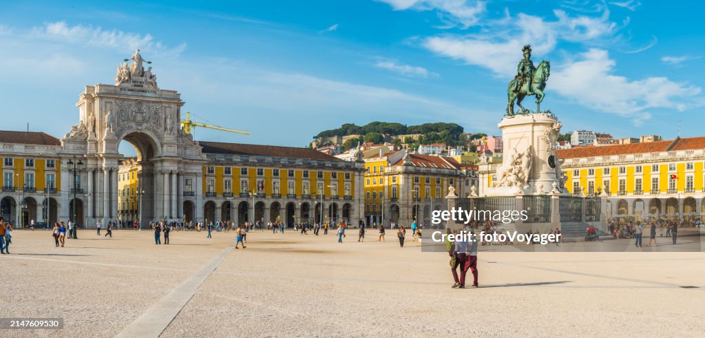Lisbon people strolling across Praco do Comercio landmark panorama Portugal