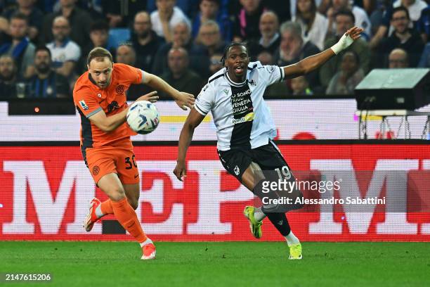Carlos Augusto of FC Internazionale and Kingsley Ehizibue of Udinese Calcio chase the ball during the Serie A TIM match between Udinese Calcio and FC...