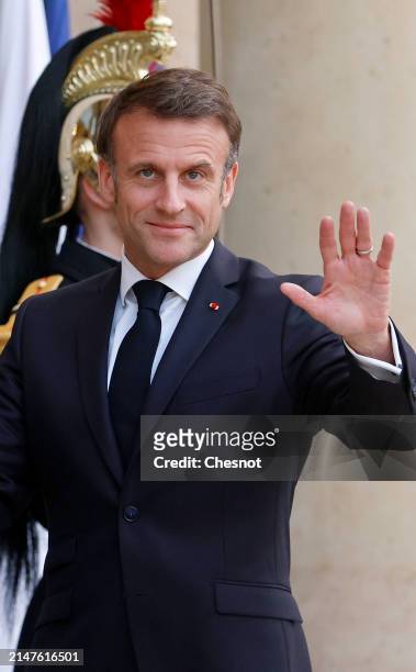 France's President Emmanuel Macron gestures as he waits for Serbia's President Aleksandar Vucic prior to their working dinner at the presidential...