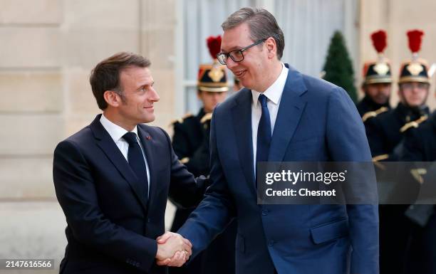 France's President Emmanuel Macron welcomes Serbia's President Aleksandar Vucic prior to their working dinner at the presidential Elysee Palace on...