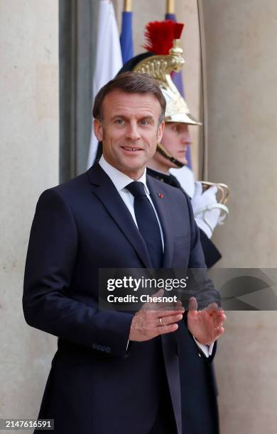 France's President Emmanuel Macron gestures as he waits for Serbia's President Aleksandar Vucic prior to their working dinner at the presidential...