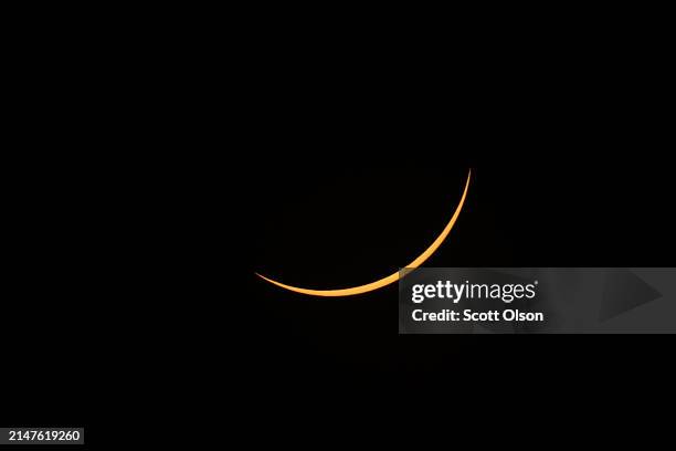 The moon eclipses the sun viewed from the campus of Southern Illinois University on April 08, 2024 in Carbondale, Illinois. People have travelled...