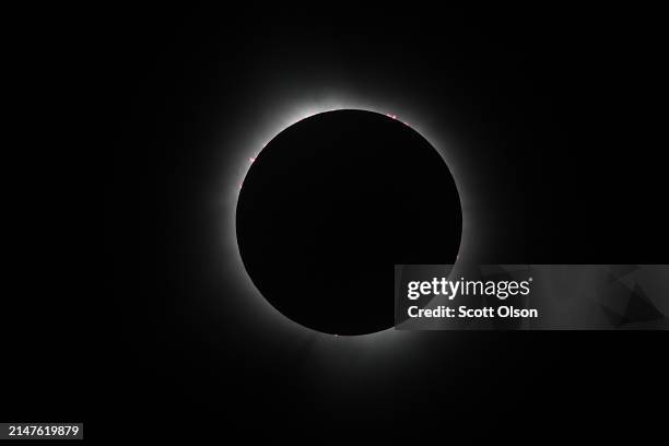 The moon eclipses the sun viewed from the campus of Southern Illinois University on April 08, 2024 in Carbondale, Illinois. People have travelled...