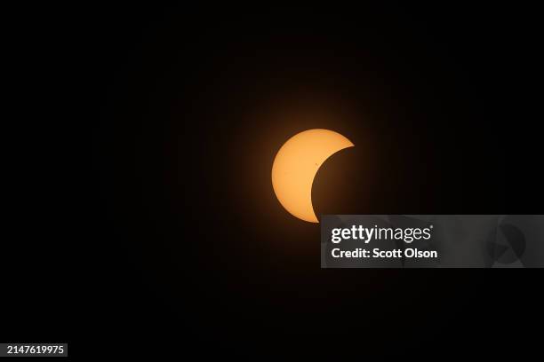 The moon eclipses the sun viewed from the campus of Southern Illinois University on April 08, 2024 in Carbondale, Illinois. People have travelled...