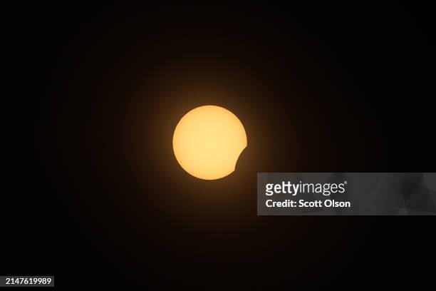 The moon eclipses the sun viewed from the campus of Southern Illinois University on April 08, 2024 in Carbondale, Illinois. People have travelled...