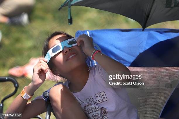 People prepare for the start of the total eclipse on the campus of Southern Illinois University on April 08, 2024 in Carbondale, Illinois. People...