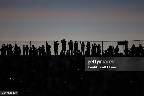 People view the total eclipse from Saluki Stadium on the campus of Southern Illinois University on April 08, 2024 in Carbondale, Illinois. Millions...