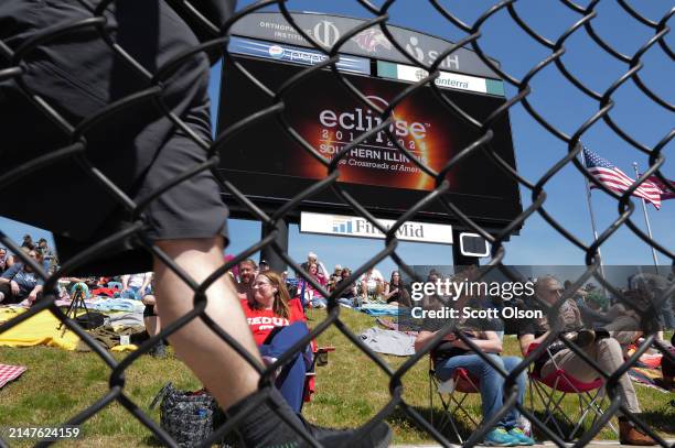 People prepare for the start of the total eclipse on the campus of Southern Illinois University on April 08, 2024 in Carbondale, Illinois. Millions...