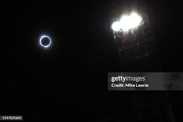 The total solar eclipse is seen near the stadium lights before the game between the Cleveland Guardians and the Chicago White Sox at Progressive...