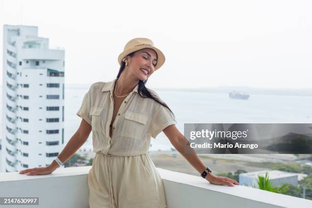 woman in the facilities of a beautiful hotel in cartagena enjoying the sun while taking care of some matters - matters stock pictures, royalty-free photos & images