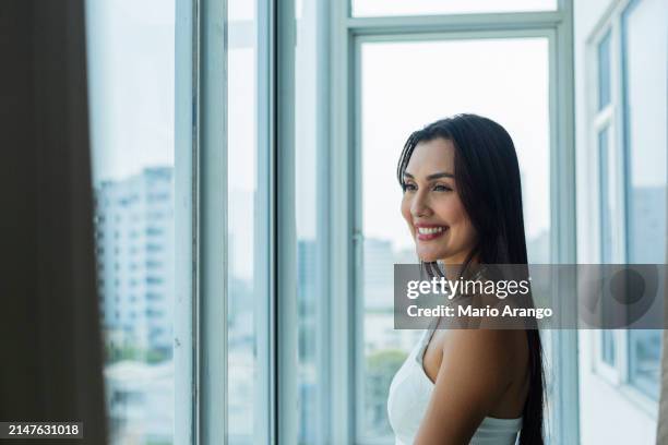 woman in the facilities of a beautiful hotel in cartagena enjoying the sun while taking care of some matters - matters stock pictures, royalty-free photos & images