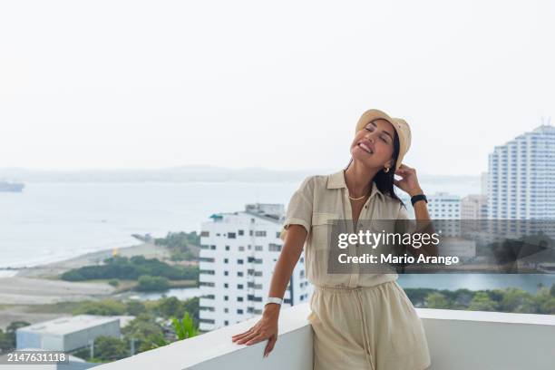 woman in the facilities of a beautiful hotel in cartagena enjoying the sun while taking care of some matters - matters stock pictures, royalty-free photos & images