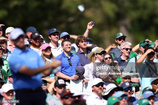 Patrons watch Patrick Cantlay of the United States on the 12th tee during a practice round prior to the 2024 Masters Tournament at Augusta National...