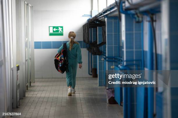 girl leaving after swimming practice - locker room stock pictures, royalty-free photos & images