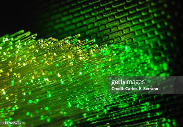 green fiber tubes against a green brick patten wall - yonkers stock pictures, royalty-free photos & images