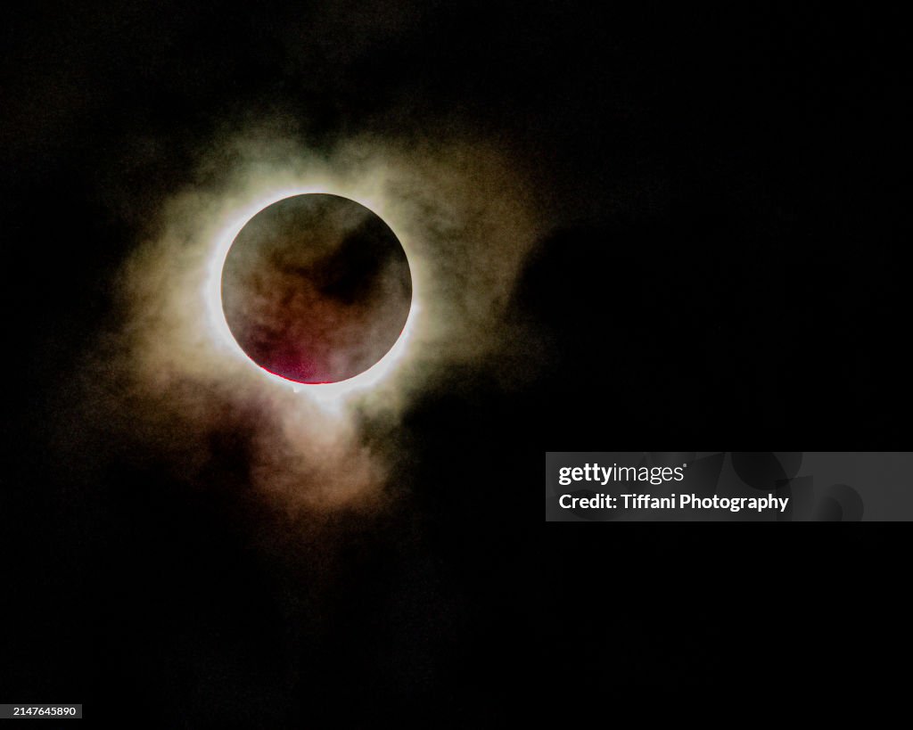 Eclipse 2024 Meadville Pennsylvania with Red Burst of Light and Cloud Cover