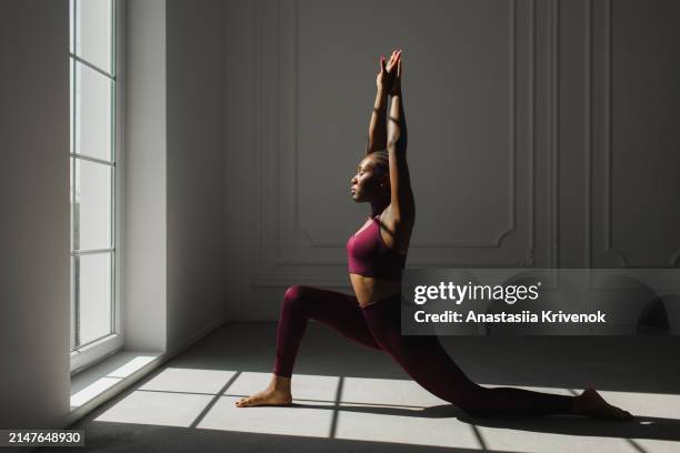 sporty beautiful black woman in red sportswear. - metodo pilates foto e immagini stock