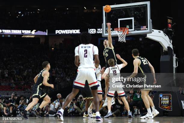 Zach Edey of the Purdue Boilermakers blocks a shot attempt by Cam Spencer of the Connecticut Huskies in the first half during the NCAA Men's...