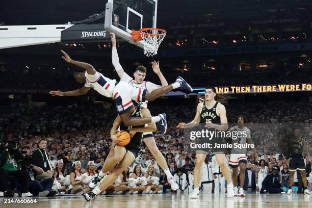 Hassan Diarra of the Connecticut Huskies flips over Trey Kaufman-Renn of the Purdue Boilermakers in the first half during the NCAA Men's Basketball...