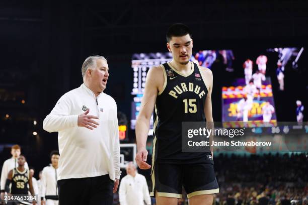 Head coach Matt Painter of the Purdue Boilermakers talks with Zach Edey of the Purdue Boilermakers as the walk to the locker room at halftime against...