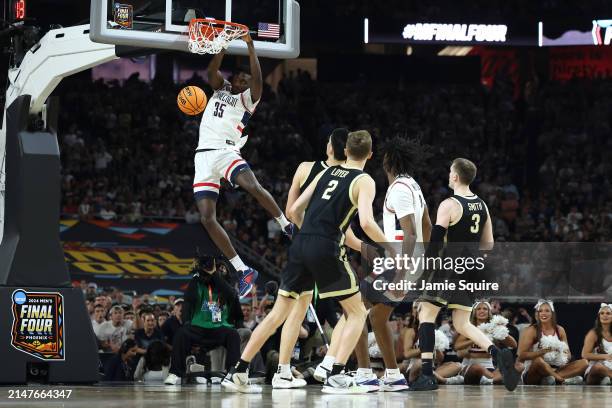 Samson Johnson of the Connecticut Huskies dunks the ball in the second half against the Purdue Boilermakers during the NCAA Men's Basketball...