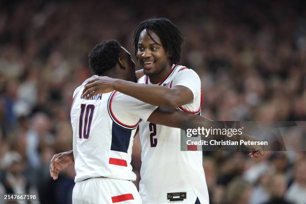 Hassan Diarra and Tristen Newton of the Connecticut Huskies celebrate after beating the Purdue Boilermakers 75-60 to win the NCAA Men's Basketball...