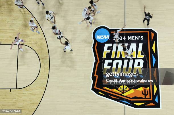 Connecticut Huskies celebrate during the second half in the NCAA Men's Basketball Tournament National Championship game at State Farm Stadium on...