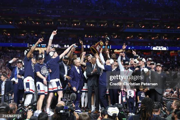 The Connecticut Huskies celebrate with the trophy after beating the Purdue Boilermakers 75-60 to win the NCAA Men's Basketball Tournament National...