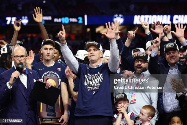 Head coach Dan Hurley of the Connecticut Huskies celebrates with his team during the trophy ceremony after beating the Purdue Boilermakers 75-60 to...