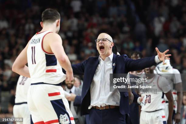 Head coach Dan Hurley and Alex Karaban of the Connecticut Huskies celebrate after beating the Purdue Boilermakers 75-60 to win the NCAA Men's...