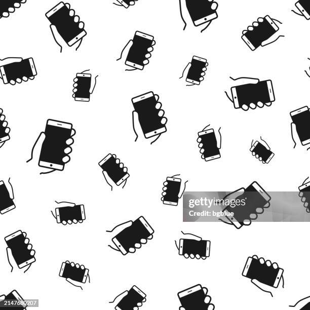 hands holding mobile phone. seamless pattern. icons on white background - using tablet blank screen stock illustrations