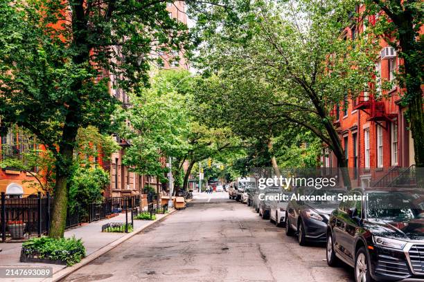 streets with green trees in west village in summer, new york, usa - west village stock pictures, royalty-free photos & images