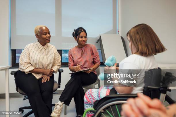 doctor's listening to a young patient - outpatient care stock pictures, royalty-free photos & images