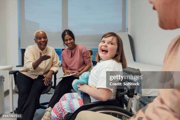 happy young girl at a hospital appointment - disability stock pictures, royalty-free photos & images