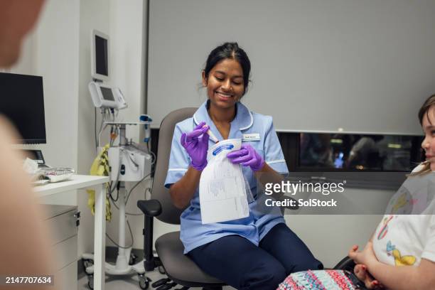 smiling nurse - outpatient care stock pictures, royalty-free photos & images